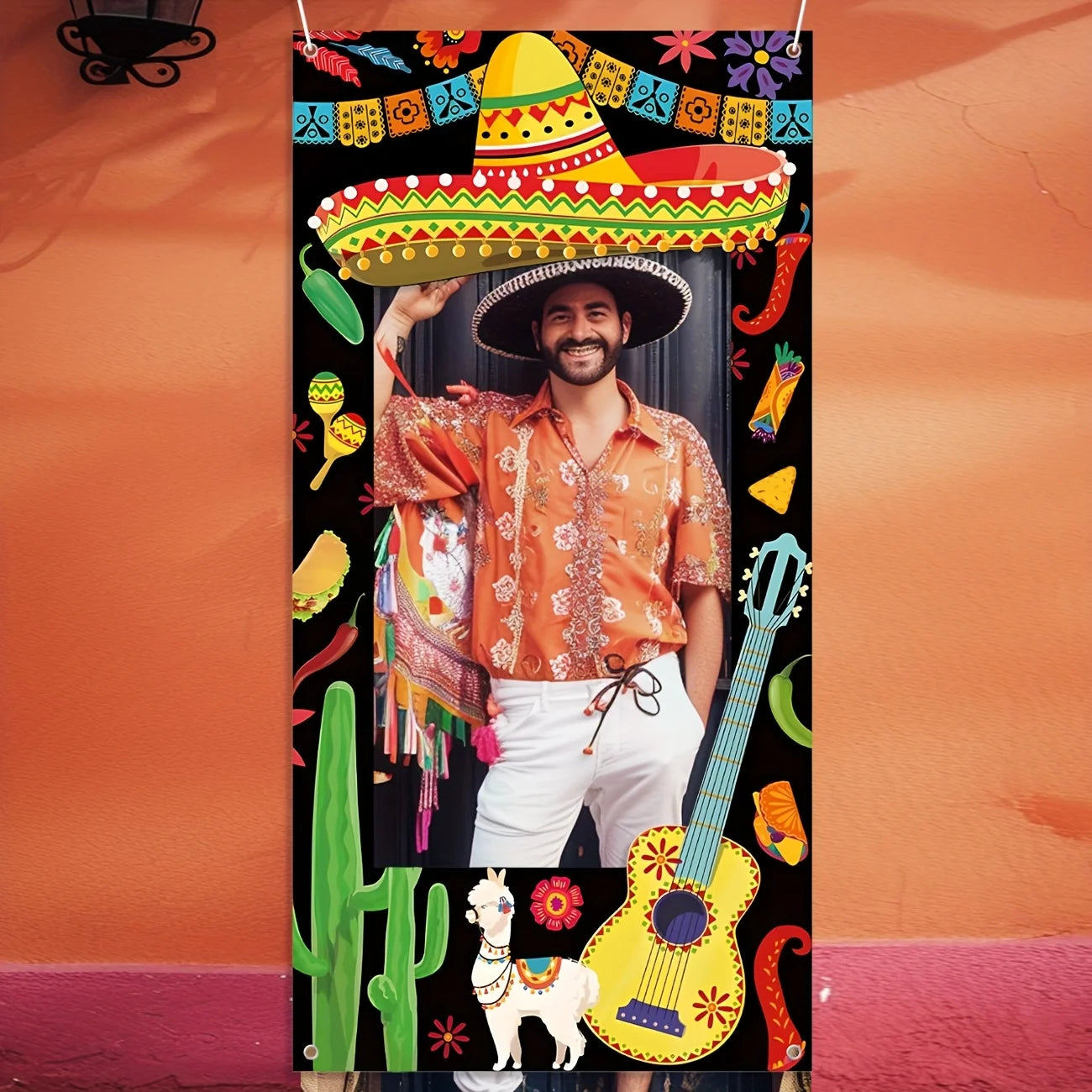 Person wearing a sombrero with colorful decorations on a black background