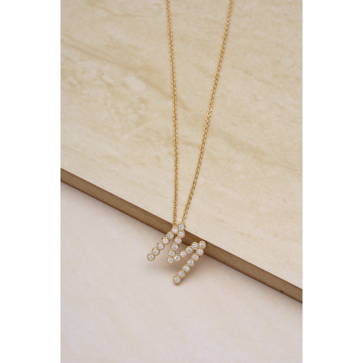 Ettika 16.5" Simple Crystal Initial "M" Pendant Necklace in 18k Gold Plate Over Brass and Steel