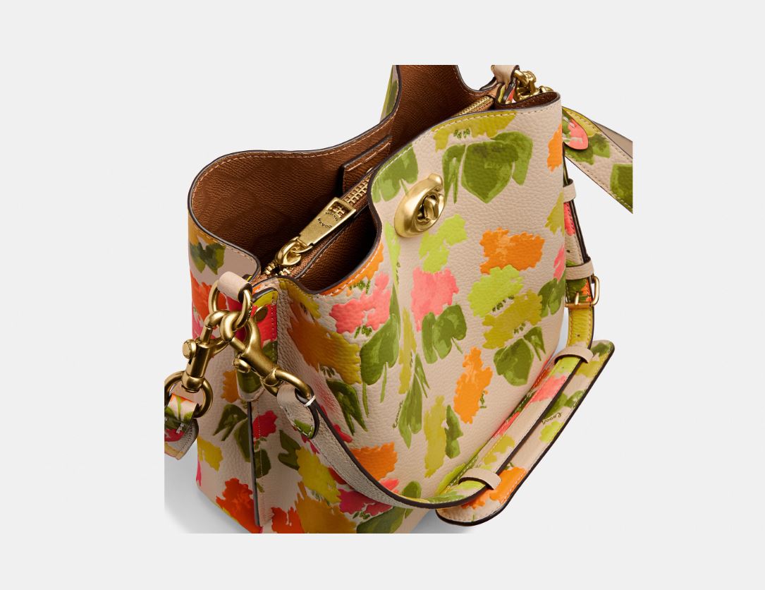 Bolso tipo cubo de piel con estampado floral Willow Pebble de Coach, color amarillo